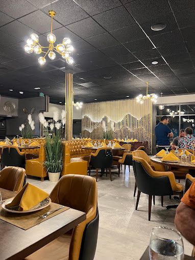 Tables set under a gold chandelier
