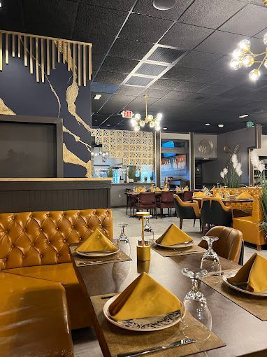 Mustard leather booths beside a mural wall